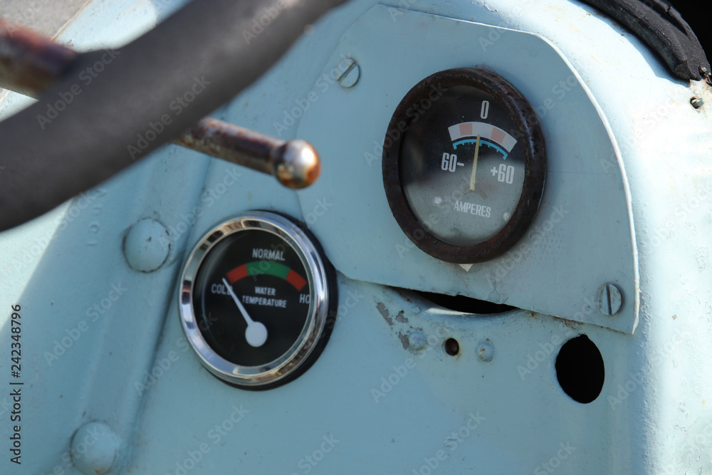 Vintage gauges on the dashboard of an old tractor. Control and