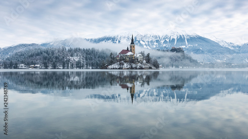 Lake bled on a misty winter morning with snow