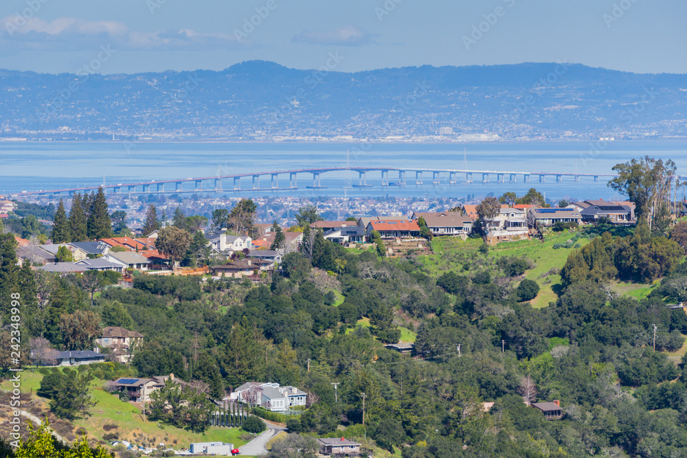 Residential neighborhood on the hills of San Francisco peninsula, Silicon Valley, San Mateo bridge in the background, California