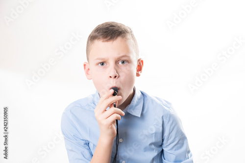 Boy with whistle on white background
