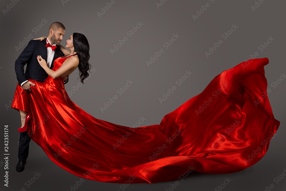 Fototapeta Dancing Couple, Woman in Red Dress and Elegant Man in Suit, Flying Waving Fabric