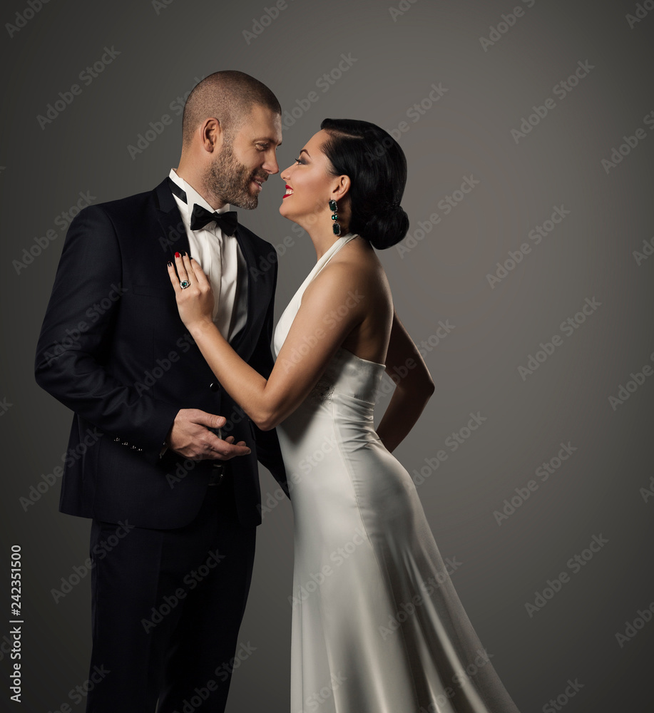Couple Fashion Portrait, Elegant Man in Black Suit and Beautiful Woman in White Dress Couple Fashion Portrait, Elegant Man in Black Suit and Beautiful Woman in White Dress