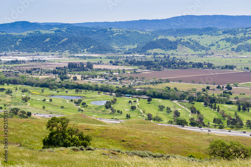 Aerial view of golf course and agricultural fields, mountain background, south San Francisco bay, San Jose, California