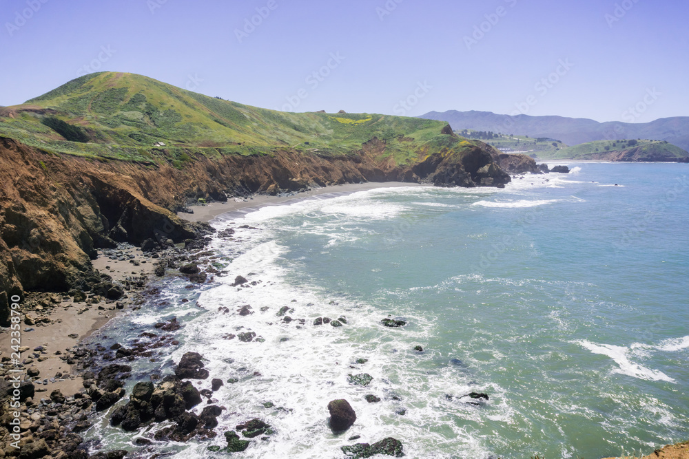 Sandy beach and eroded cliffs on the Pacific Ocean coastline, Mori Point, Pacifica, California