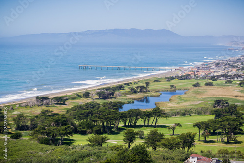 Aerial view of Pacifica Municipal Pier and Sharp Park golf course as seen from the top of Mori Point, Marin County in the background, California photo