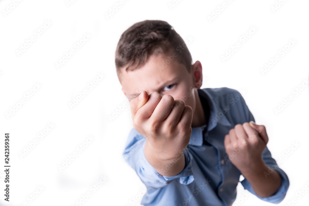 Violence in school - fist of a young child in front of his face Violence in school - fist of a young child in front of his face