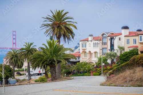 Residential street in the Sea Cliff neighborhood, Golden Gate bridge in the background, San Francisco, California