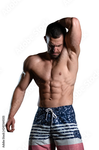 isolated brutal athletic man with a muscular body poses, showing off his muscles. The concept of a healthy lifestyle