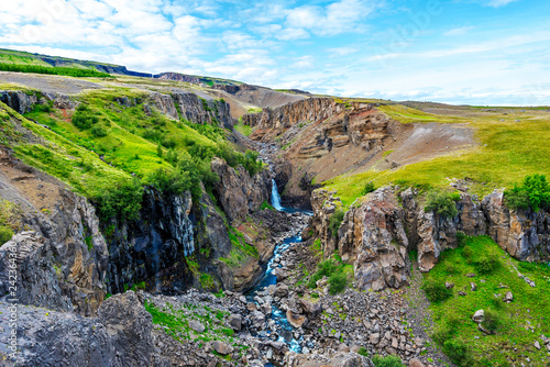 Rocky landscape with water course coming down from Hengifoss and Litlanesfoss waterfalls