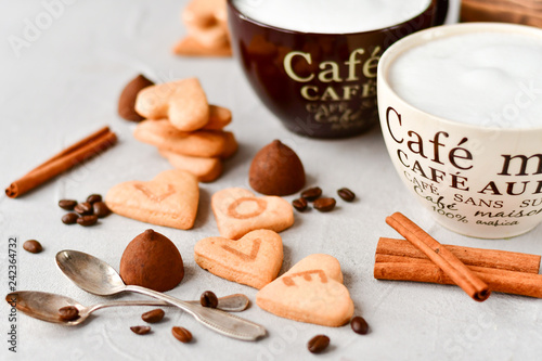 romantic Breakfast: two cups of coffee and cookies in the shape of hearts, on the cookie letters LOVE. the concept of a gift for Valentine's day on February 14. selective focus