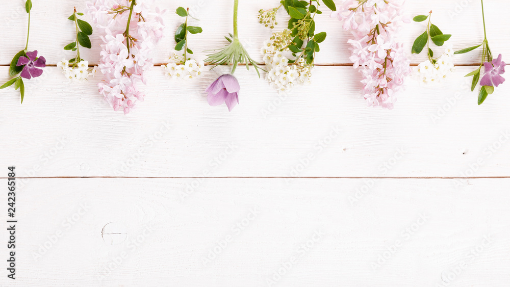 Festive flower composition on the white wooden background. Overhead view Festive flower composition on the white wooden background. Overhead view
