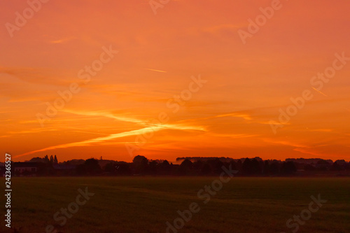 An amazing sunrise with waterdrops on grass