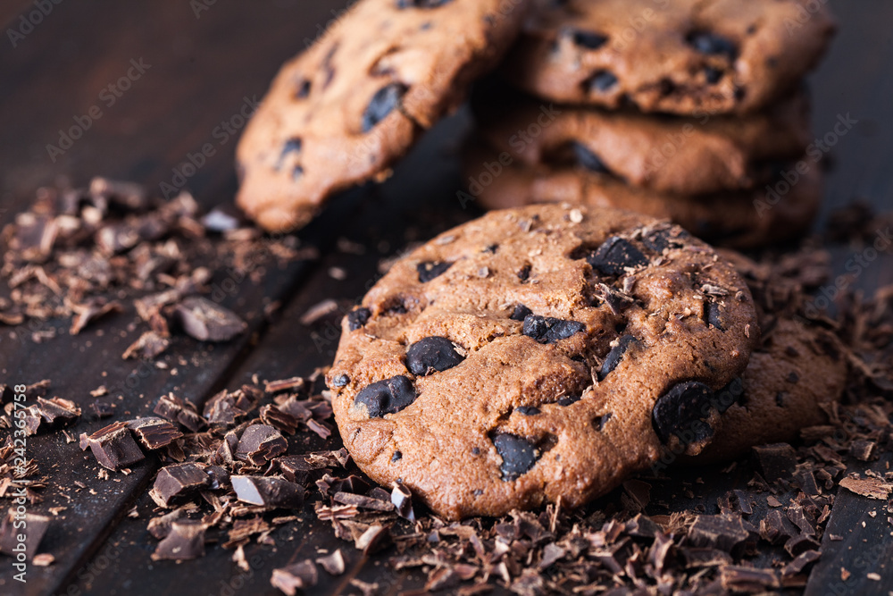 Homemade chocolate cookies on dark old wooden table. Chocolate chips cookies shot. Homemade chocolate cookies on dark old wooden table. Chocolate chips cookies shot.