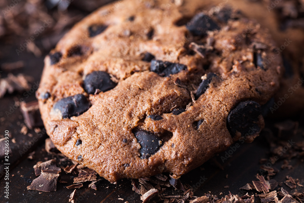 Homemade chocolate cookies on dark old wooden table. Chocolate chips cookies shot. Homemade chocolate cookies on dark old wooden table. Chocolate chips cookies shot.