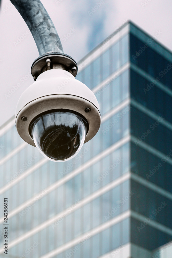 Security camera with a glass building on the background Security camera with a glass building on the background