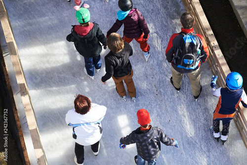 Group of unidentified skaters on ice outdoors and enjoying winter sports. View from above
