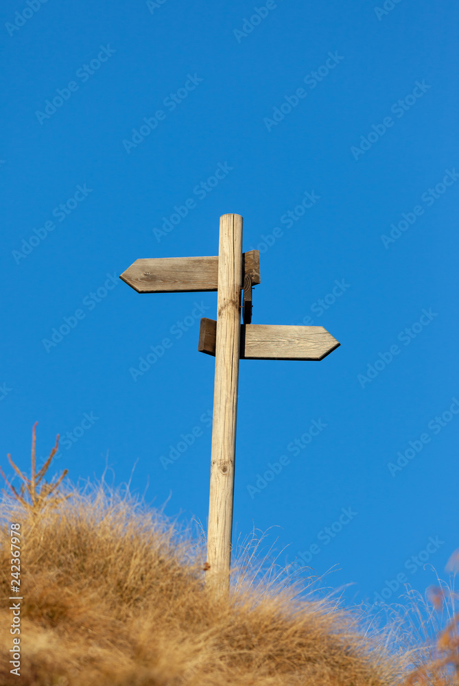 Wooden signpost and blue sky. Copy space on the top. Wooden signpost and blue sky. Copy space on the top.