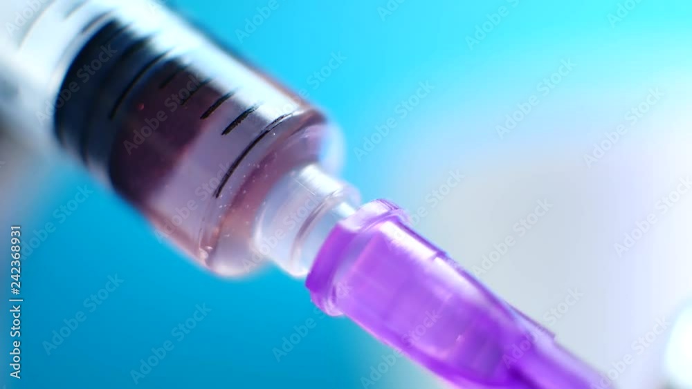 Doctors with syringe on blue background, injection in hospital Doctors with syringe on blue background, injection in hospital