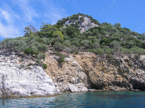 Beautiful natural landscape sunny summer day. Panorama of a stone island among the sea,