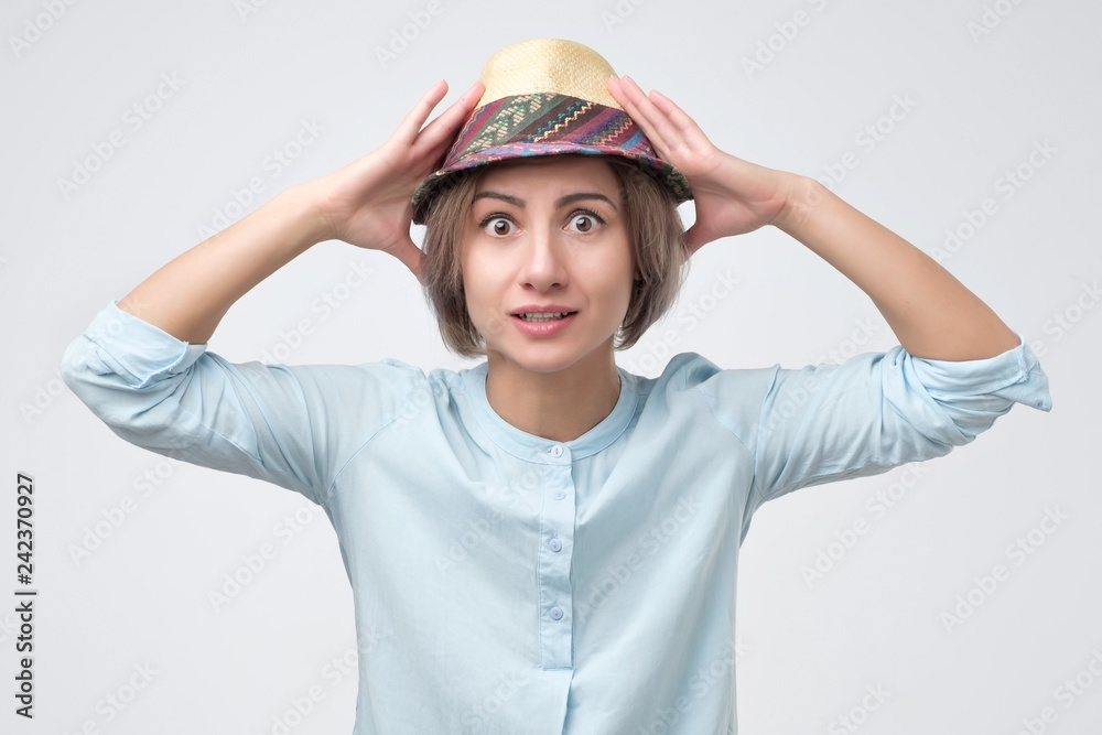 Confused woman puts her hands on the head Confused woman puts her hands on the head