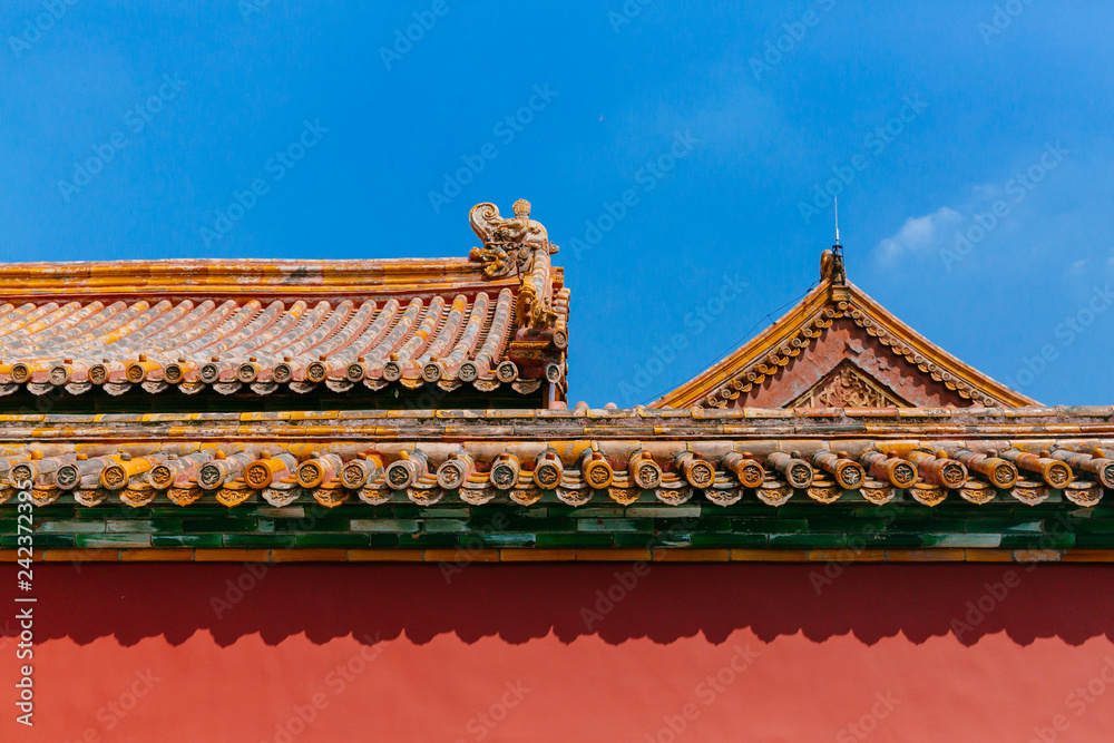 Traditional Chinese architecture with red wall and yellow roof tiles, in Forbidden City, under blue sky, in Beijing, China Traditional Chinese architecture with red wall and yellow roof tiles, in Forbidden City, under blue sky, in Beijing, China