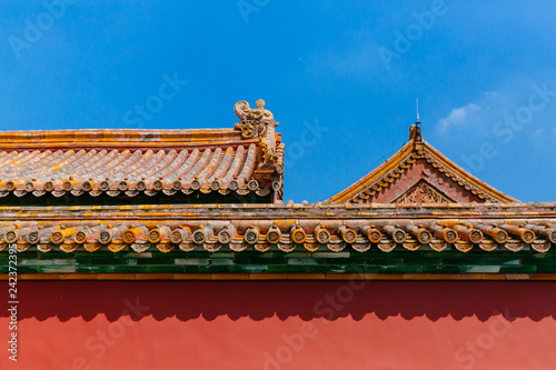 Traditional Chinese architecture with red wall and yellow roof tiles, in Forbidden City, under blue sky, in Beijing, China
