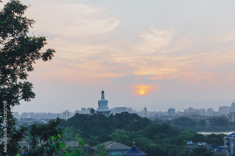 White Pagoda of Beihai Park against sunset, viewed from Jingshan Park, in Beijing, China
