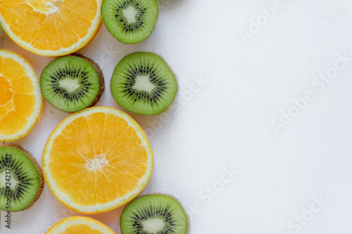 Fresh kiwi and orange sliced. Background for the profile, design, printing with fruit. The basis for the banner with orange and kiwi. Fresh and natkralnye vitamins. Healthy food. Flat lay, top view