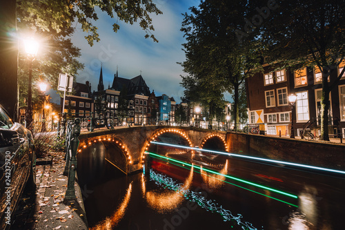 Light trails at famous canals in Amsterdam at dusk. Long exposure shot photo