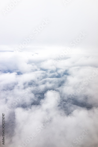 Isolated sky cloudscape with fluffy cloud and soft fog mist on aerial high angle vertical view of from airplane
