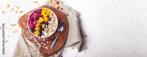 Fototapeta Naklejka Na Ścianę i Meble -  Raspberries, Mango and blueberries in a Bowl. Healthy breakfast concept with yoghurt