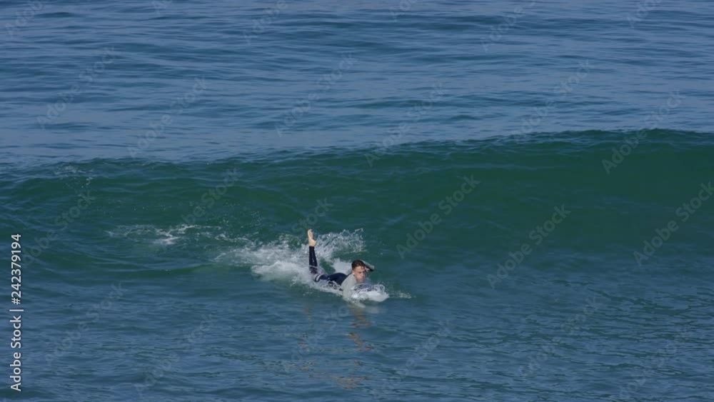 Surfer Paddles Hard To Catch Wave, He Stands Up And Rides It, Then Wipes Out, Slow Motion Surfer Paddles Hard To Catch Wave, He Stands Up And Rides It, Then Wipes Out, Slow Motion