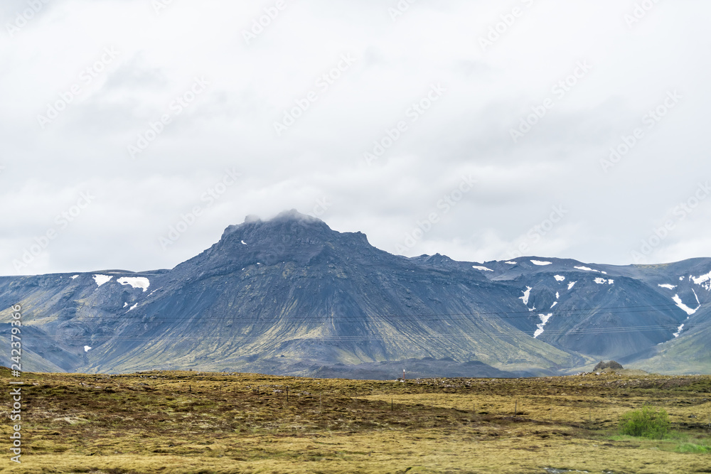 Iceland landscape view of mountain on cloudy day on south southern ring road or golden circle with power lines