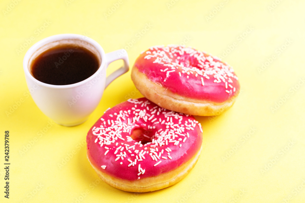Two delicious pink donuts with sprinkle and cup of coffee Two delicious pink donuts with sprinkle and cup of coffee