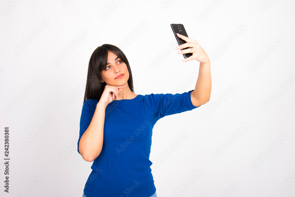 Girl on white with smartphone cell phone smiling using internet social media concept Girl on white with smartphone cell phone smiling using internet social media concept