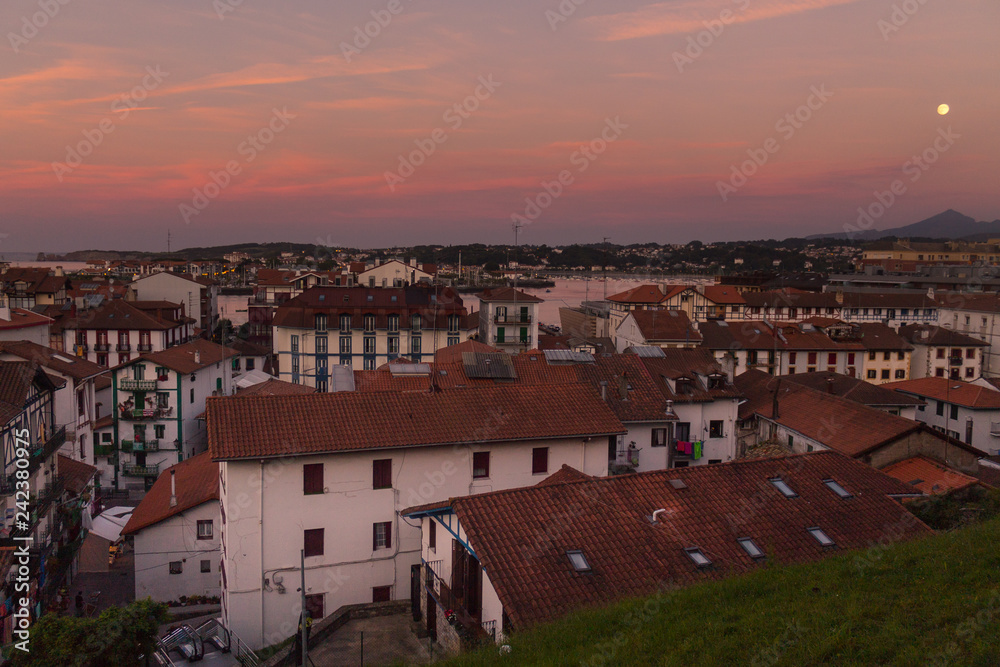 Moonset over sunset in Hondarribia, Basque Country.