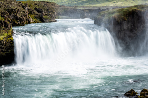 Godafoss  Iceland waterfall of the gods with long exposure smooth motion of water falling off cliff in green moss summer landscape