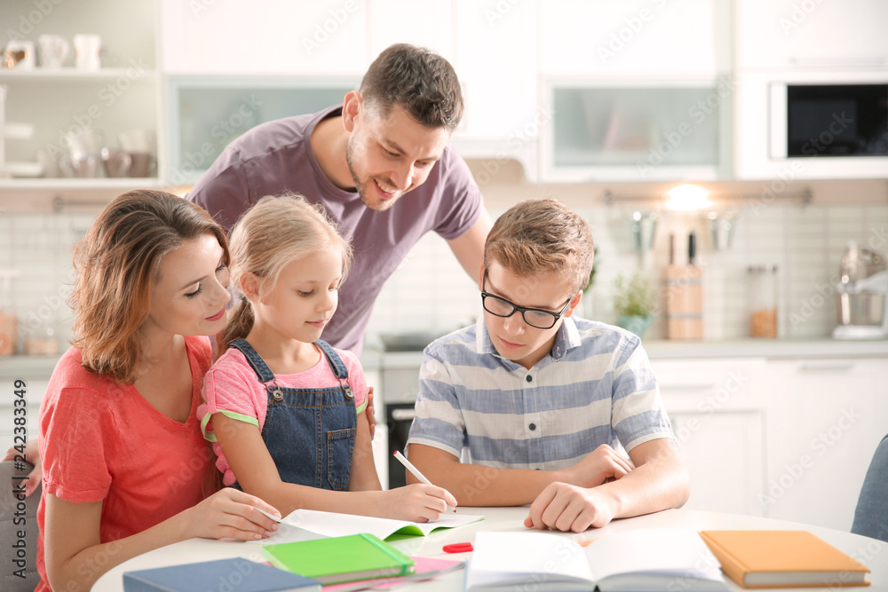 Children with parents doing homework at home Children with parents doing homework at home