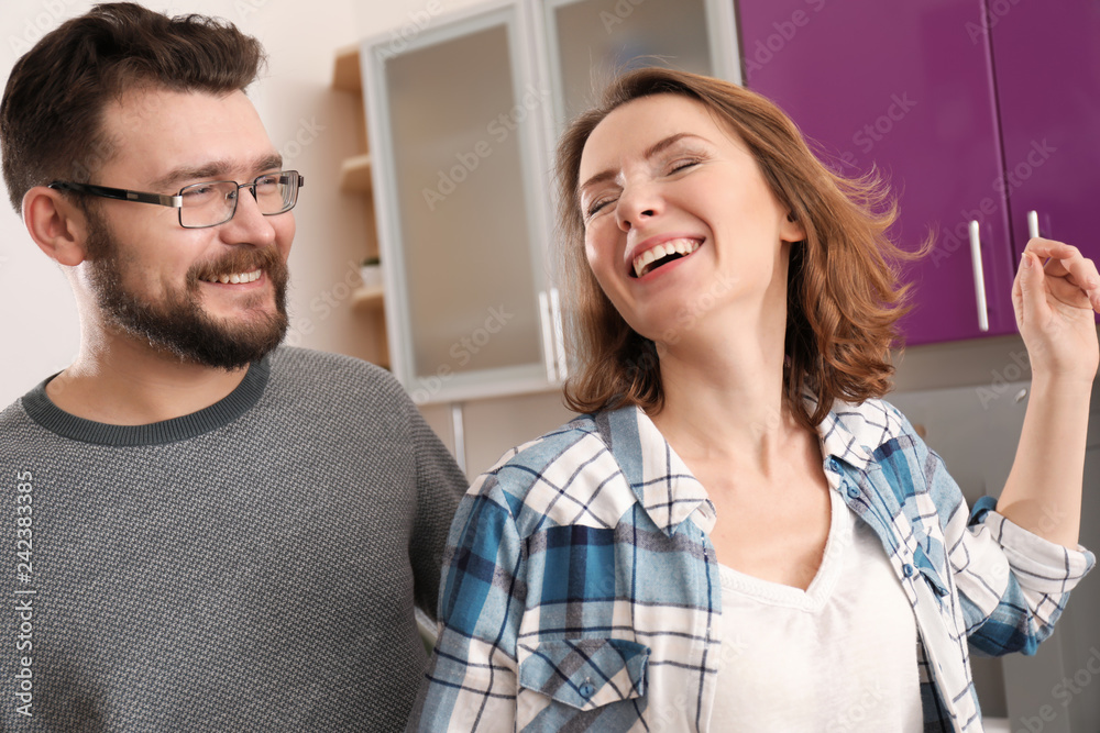 Fototapeta premium Lovely couple dancing together in kitchen