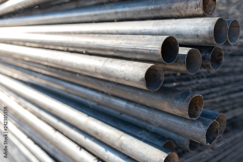 Stack of steel pipes for the construction of scaffolding.
