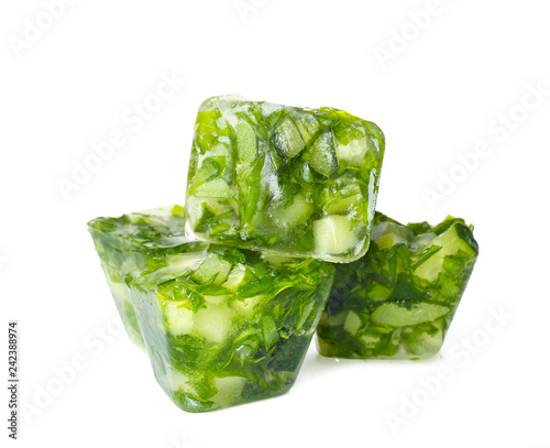 Ice cubes with cucumber slices and herbs on white background