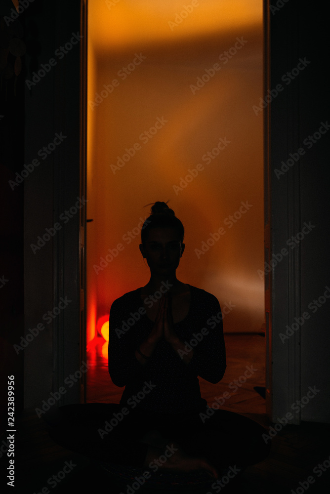 Young woman meditating in home ambient.