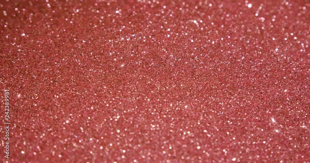 Rose gold glitter texture surface rotating. Close up 4k backdrop footage.