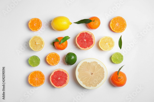 Different citrus fruits on white background, flat lay