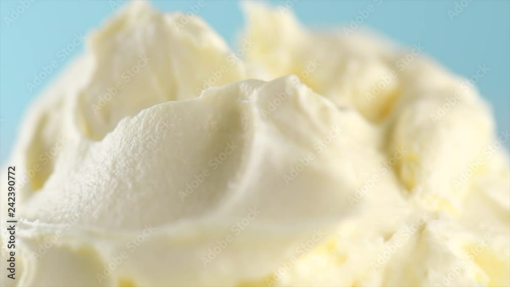 Mascarpone cream cheese closeup. Mascarpone soft milk cream rotated on blue background. Homemade ice cream, yoghurt. Slow motion 4K UHD video footage. 3840X2160 Mascarpone cream cheese closeup. Mascarpone soft milk cream rotated on blue background. Homemade ice cream, yoghurt. Slow motion 4K UHD video footage. 3840X2160