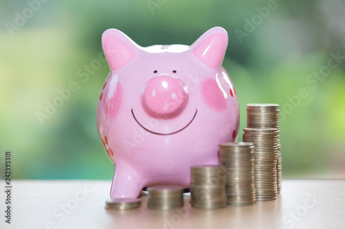 Piggy bank with growth coins which means grwoth business success concept photo