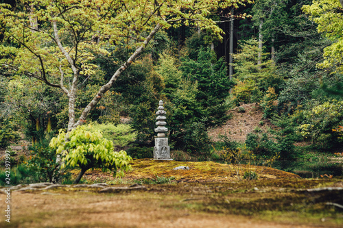 Green park with a monument and stone rock statue photo