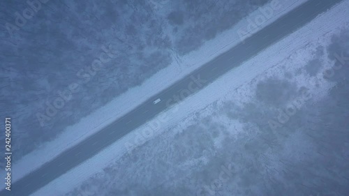 Wallpaper Mural Aerial view of traffic on the road passing through the winter forest in blizzard Torontodigital.ca