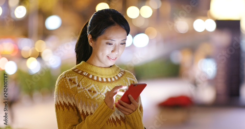 Woman use of mobile phone at the street