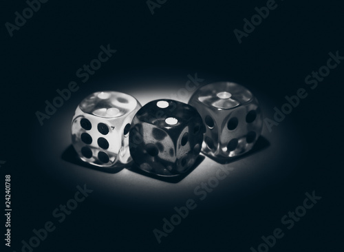 Multi color dice shinning in the dark by soft light